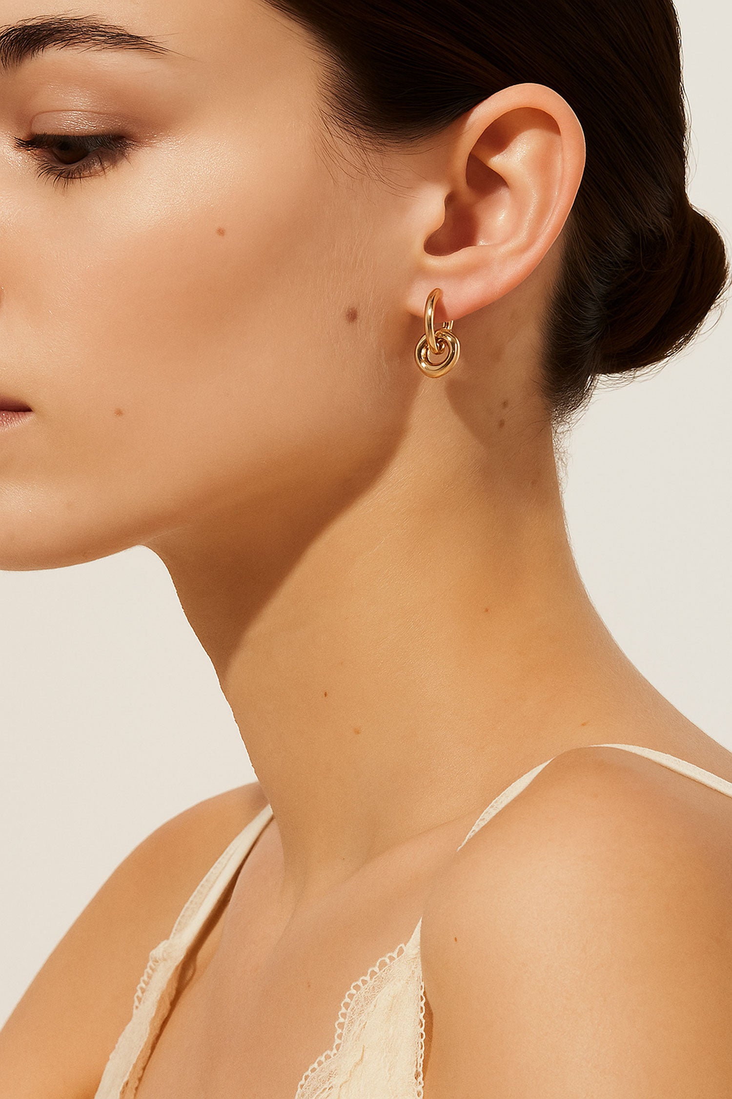 Close-up of a woman wearing stylish gold hoop earrings